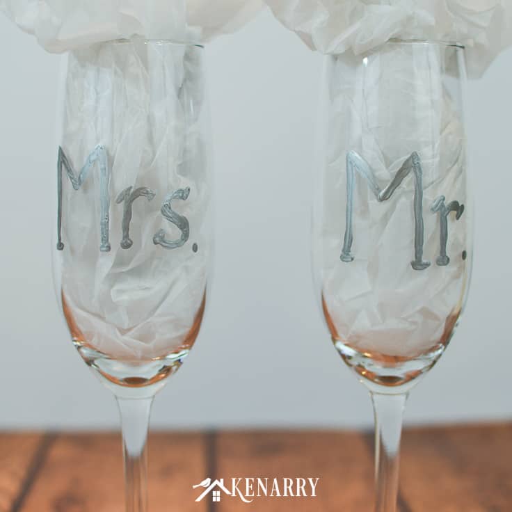 Learn how to make personalized hand painted toasting glasses. These Mr. and Mrs. champagne flutes are an easy DIY gift for the bride and groom, perfect for a bridal shower, wedding or anniversary. #weddinggifts #weddingideas #weddingreception #handpainted