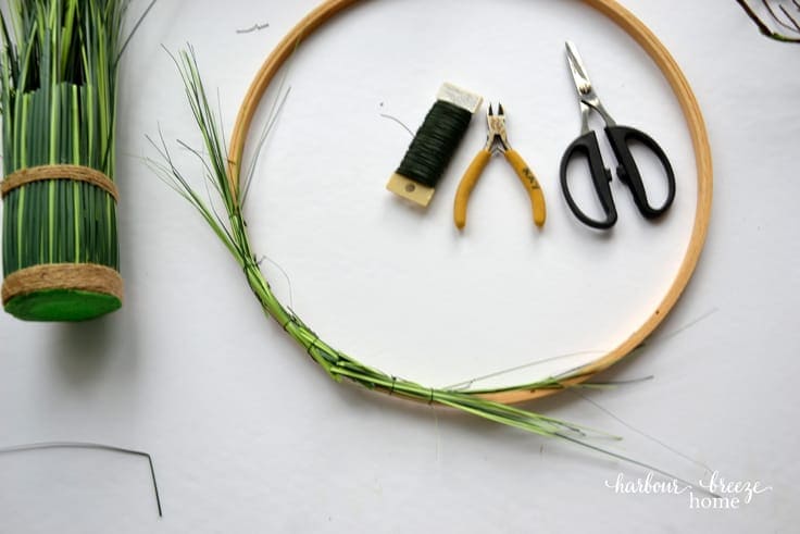 wired on greenery on an embroidery hoop wreath