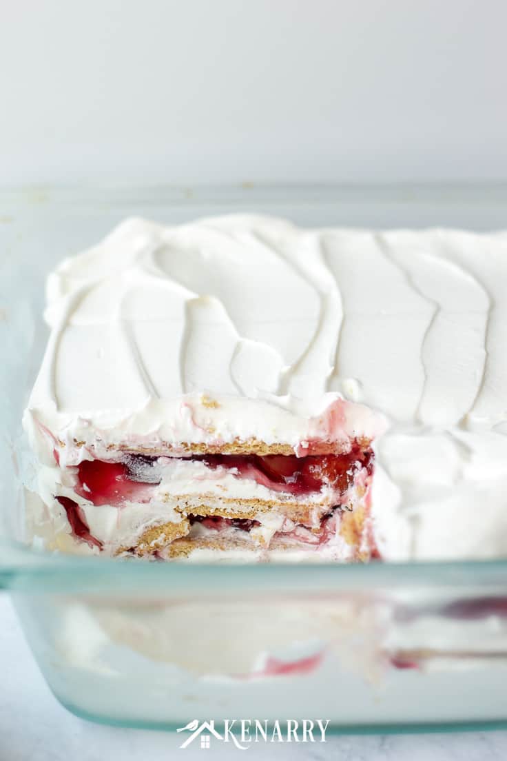 No Bake Cherry Pie Ice Box Cake recipe with a slice missing in a pan