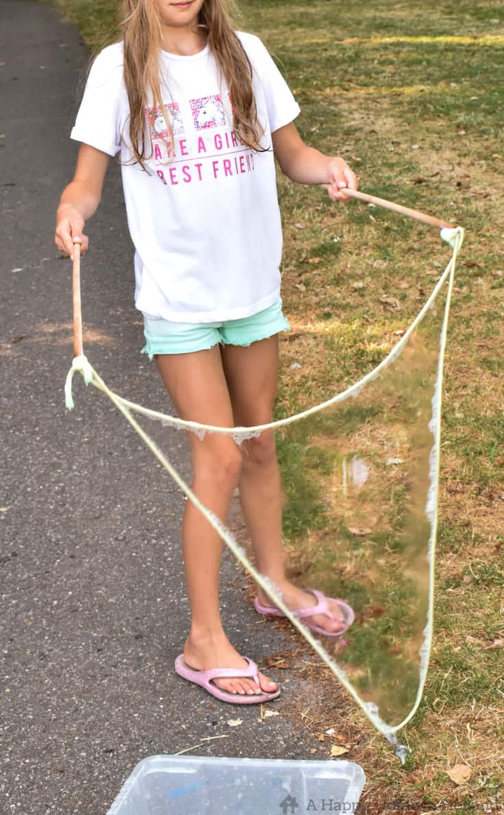 Learn how to create super fun giant bubbles with a couple of sticks and some string! #summer #summeractivities #kidsactivities #stem