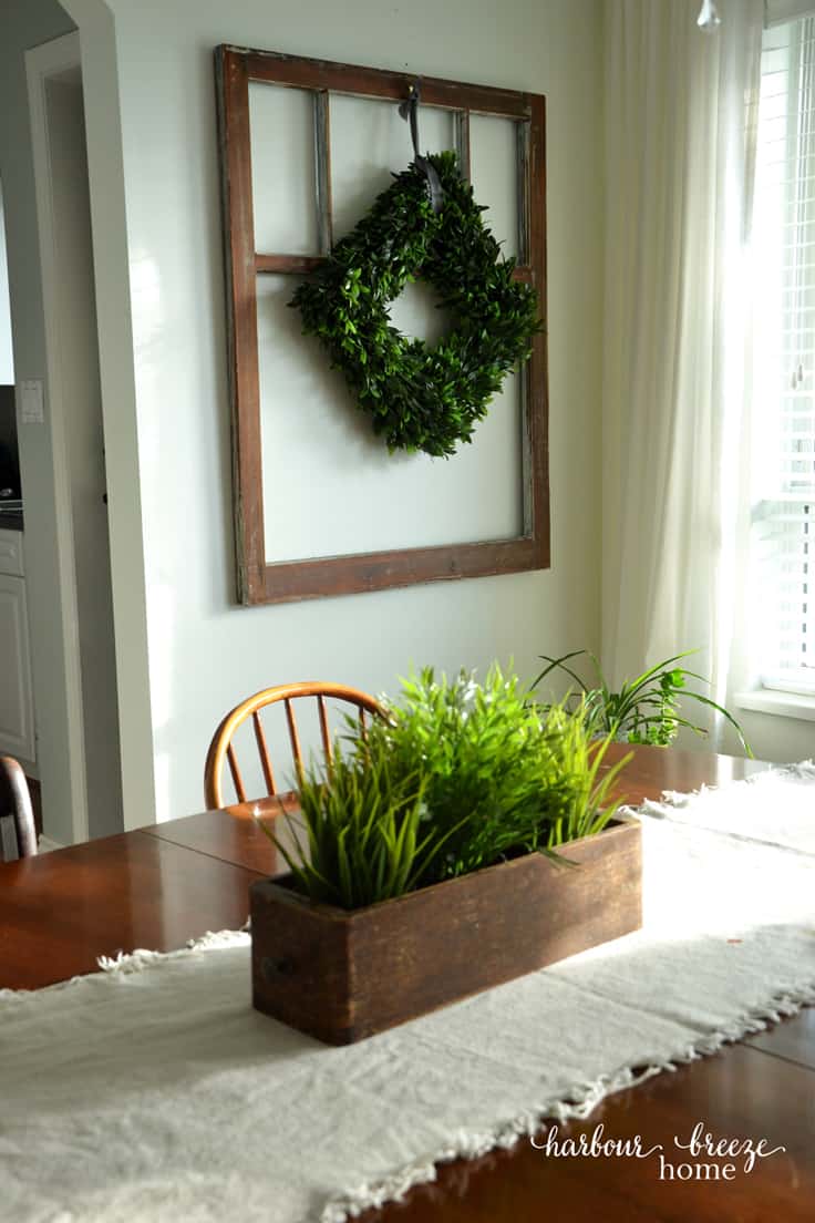 Antique Window with boxwood wreath hung in front of it