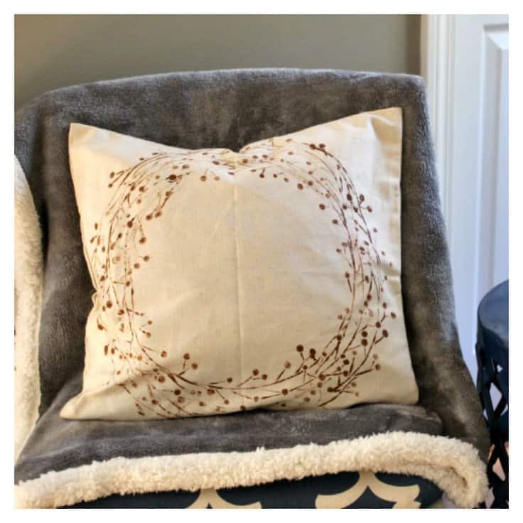 Learn how to make a beautiful double-sided stenciled pillow for your home! The best part about this tutorial...it's an easy no sew DIY that uses pillow covers! Perfect for living rooms or bedrooms! #diypillow #homedecor #kenarry