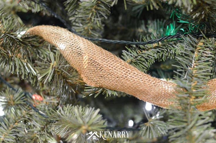 Love farmhouse style decor? Create a rustic Christmas tree quickly and easily this holiday season using wide burlap ribbon as garland.