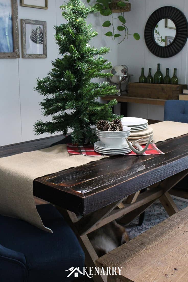 A small Christmas tree, sleigh or a extra large holiday centerpiece on a burlap table runner adds height and dramatic style to your holiday decor and dining room table. #christmasdecor #rusticchristmas #kenarry