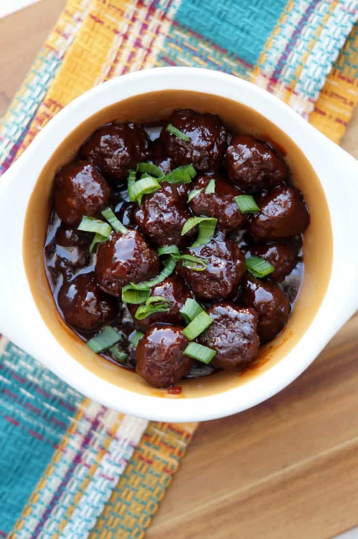 These Slow Cooker sweet and spicy Sriracha Meatballs are the perfect bite size appetizer for any party! Your guests will love the bold sweet and spicy flavors from the grape jelly and Sriracha in this amazing Crockpot meatball recipe! Better yet, they are so easy!