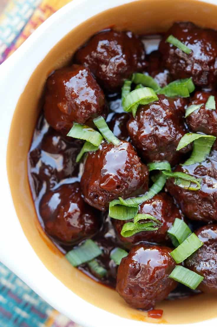 These Slow Cooker sweet and spicy Sriracha Meatballs are the perfect bite size appetizer for any party! Your guests will love the bold sweet and spicy flavors from the grape jelly and Sriracha in this amazing Crockpot meatball recipe! Better yet, they are so easy! 
