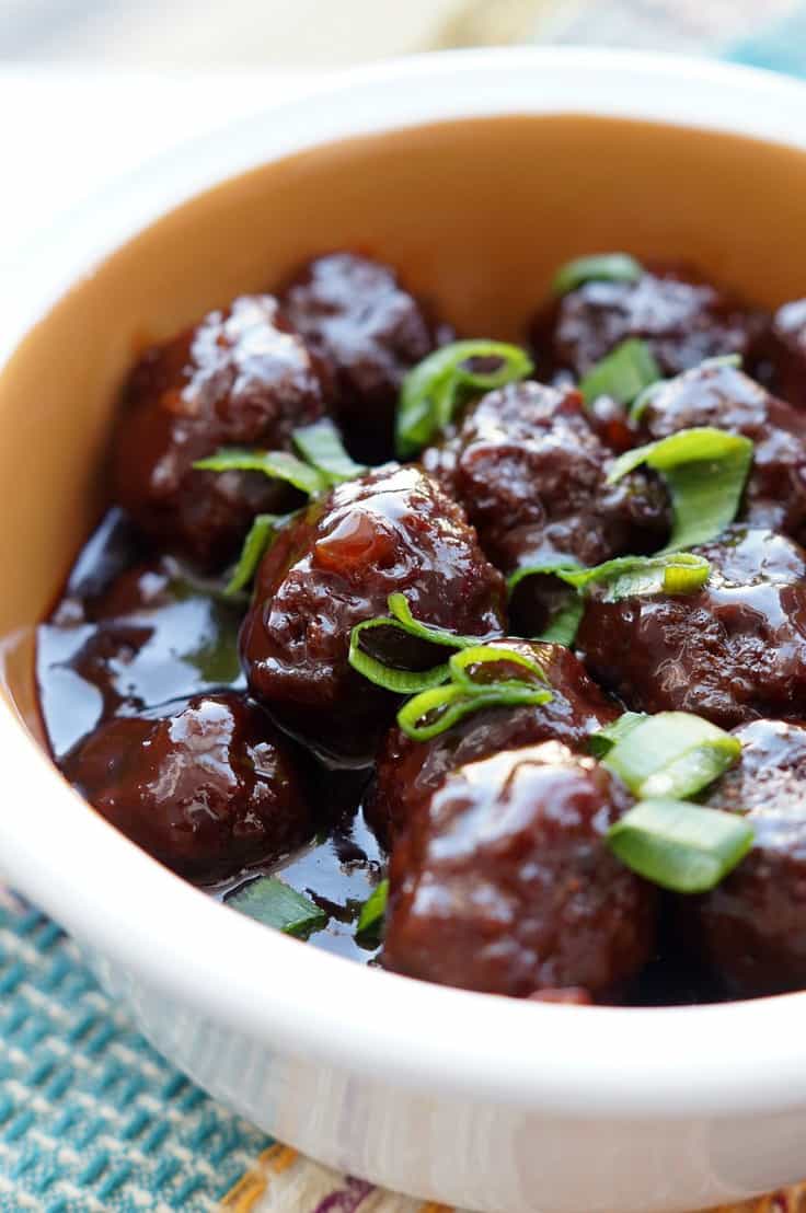 These Slow Cooker sweet and spicy Sriracha Meatballs are the perfect bite size appetizer for any party! Your guests will love the bold sweet and spicy flavors from the grape jelly and Sriracha in this amazing Crockpot meatball recipe! Better yet, they are so easy! 