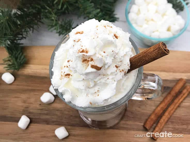 This homemade Spiked White Hot Cocoa recipe is perfect for the holidays! ﻿White chocolate flavored with some Rum Chata alcohol and topped off with whipped cream will be a huge hit at your hot chocolate bar! #hotcocoa #hotchocolate #kenerry