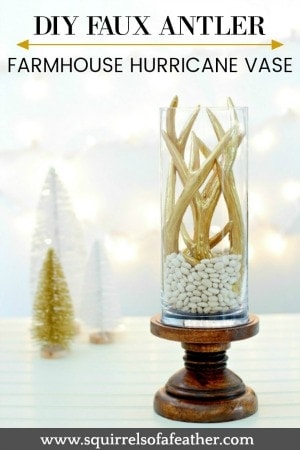 Holiday hurricane vase with gold faux antlers.