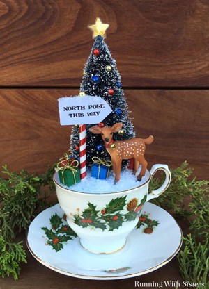 Make Teacup Christmas Scene with a bottlebrush tree and little reindeer. We'll show you how to make the North Pole sign and put it all together.