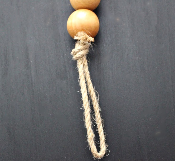 Knot tied off at end of wood bead garland