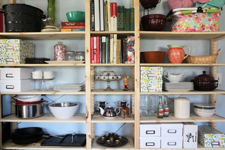  Using open shelving can be pretty and practical for kitchen organizing. All you need are a few photo boxes and some printable labels to not only hide the clutter but make it easy to find when you need it. 