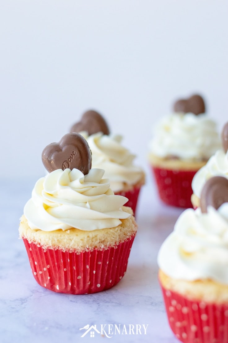 Surprise your sweetheart with this festive Valentine's Day Cupcakes recipe. This fun dessert idea has a hidden red velvet cake heart inside each of these delicious treats that is perfect for kids and adults. #valentinesday #cupcakes #kenarry