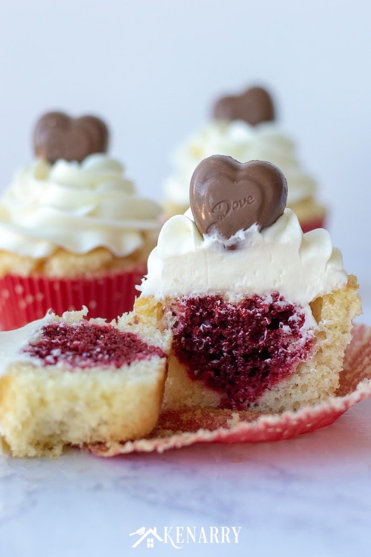 Surprise your sweetheart with this festive Valentine's Day Cupcakes recipe. This fun dessert idea has a hidden red velvet cake heart inside each of these delicious treats that is perfect for kids and adults. #valentines #valentinetreat #kenarry