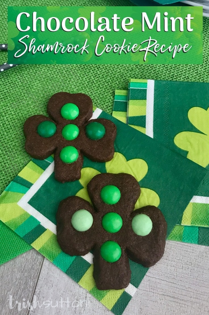 chocolate shamrock shaped cookie with green m&ms on a st. patrick's day napkin