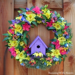 Make a colorful Summer Birdhouse Wreath featuring silk flowers of the season and a bright birdhouse! Add pretty craft birds to finish it off!