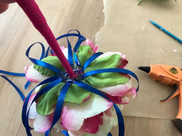 Glueing ribbons to DIY flower wand.