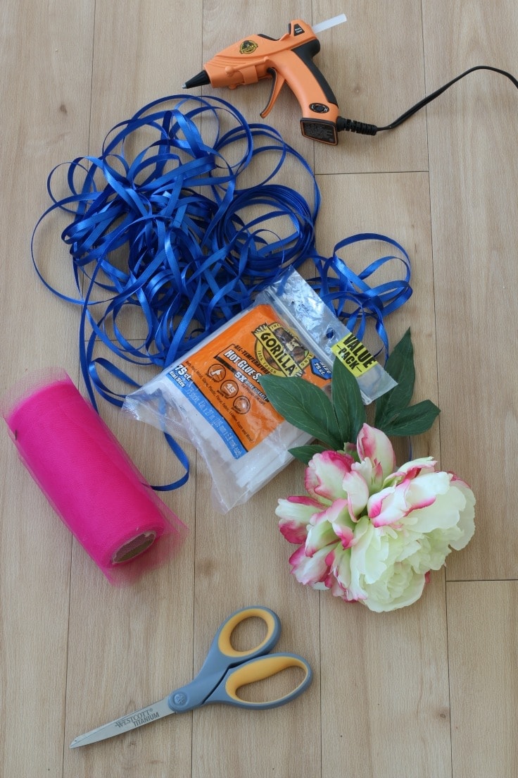 Supplies to make DIY flower wand - faux flowers, hot glue and gun, thin and thick ribbons. 