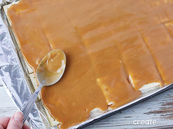 toffee and saltine crackers on a baking sheet