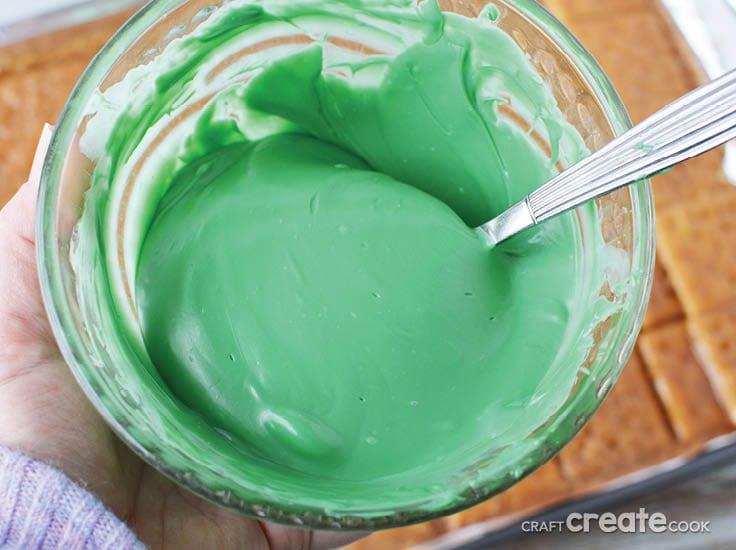 melted green candy melts in a bowl with spoon