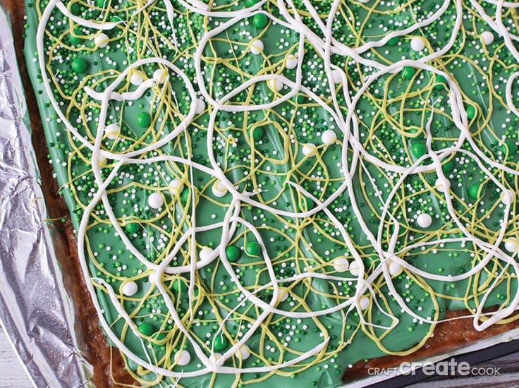St. Patrick's Day saltine crackers toffee treat with green and white sprinkles and frosting