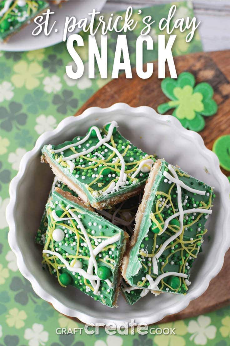 green and white saltine cracker toffee St. Patrick's Day snack in a white bowl