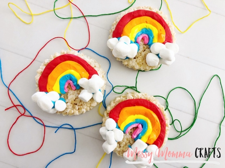 Completed Rainbow Rice Krispie treats with green blue, yellow and red string in the background. 