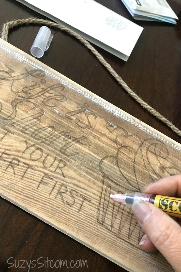 A close-up of using a Scorch marker on wood. 
