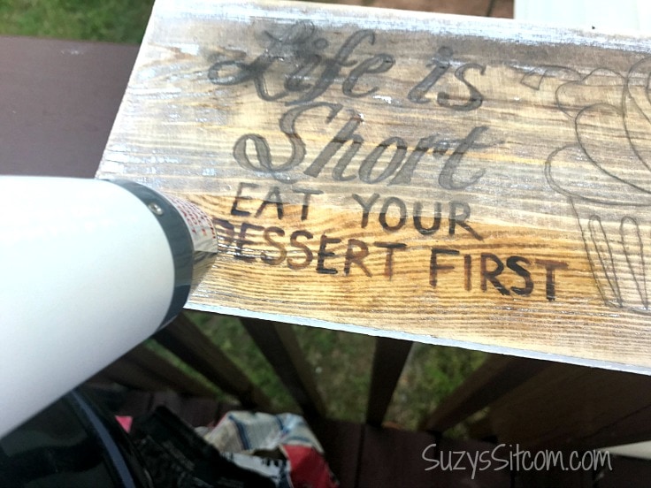 Using a heat gun on a handmade wood sign after using a Scorch pen. 