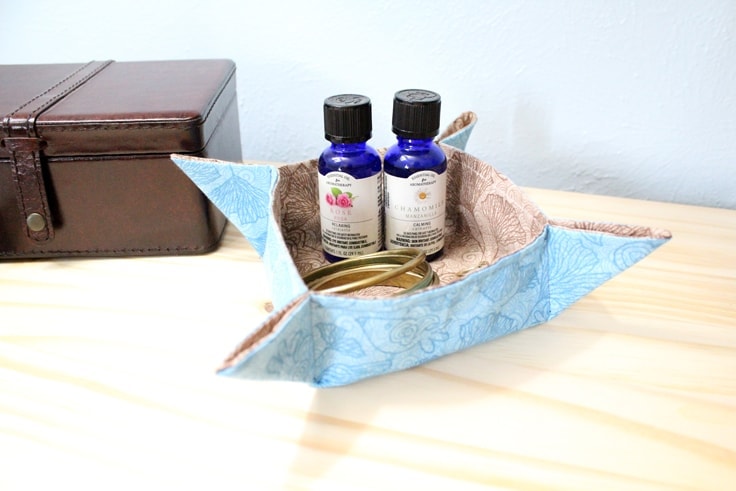 finished fabric tray sitting on a nightstand with essential oils and jewelry inside