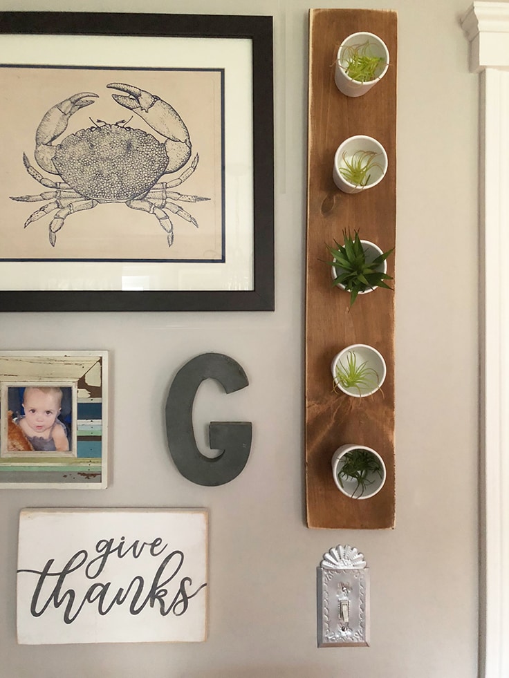 A DIY planter hanging on a gallery wall. 