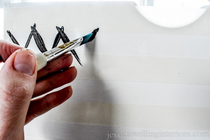 To paint a chevron pattern, just make swishes between the taped lines. Use an angled brush for best look. 