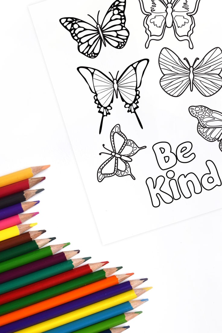 Butterfly design coloring page printable with positive message Be Kind and colored pencils.