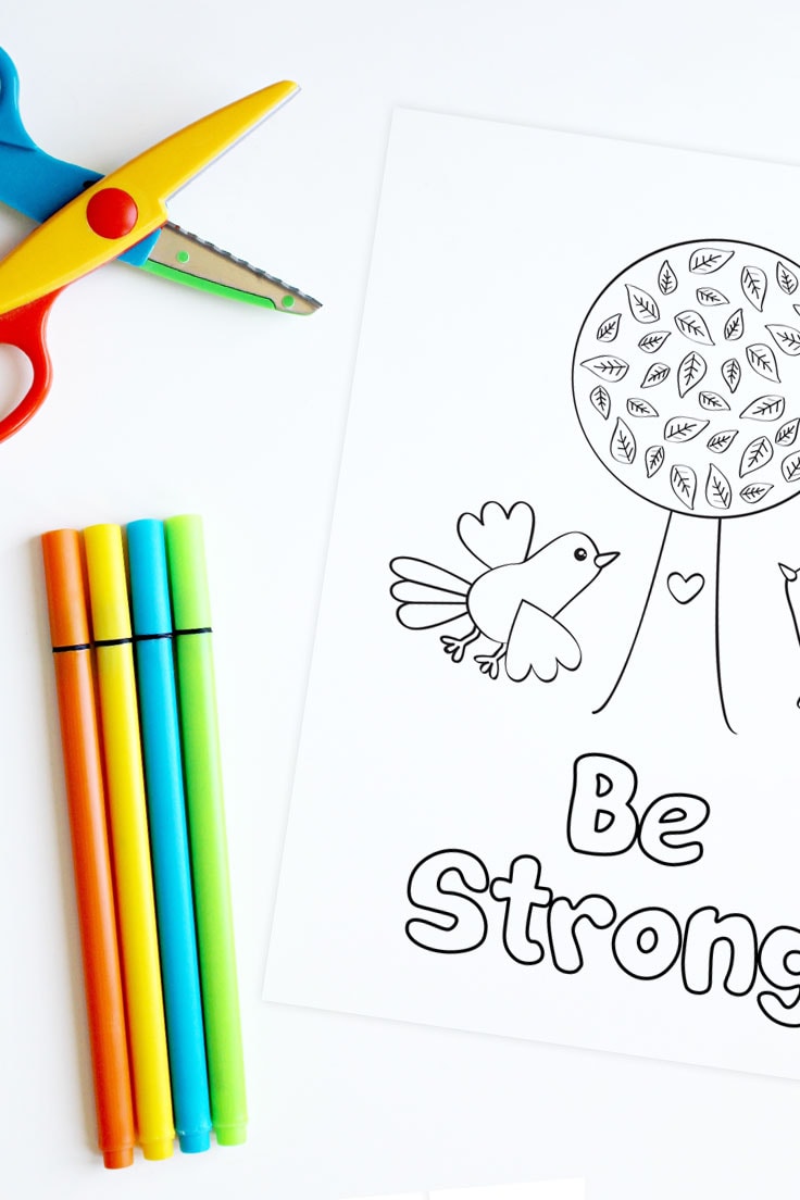 Kids scissors and markers with a printable coloring page design that features Be Strong phrase.