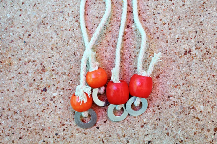 Red and orange beads on a cord with washers