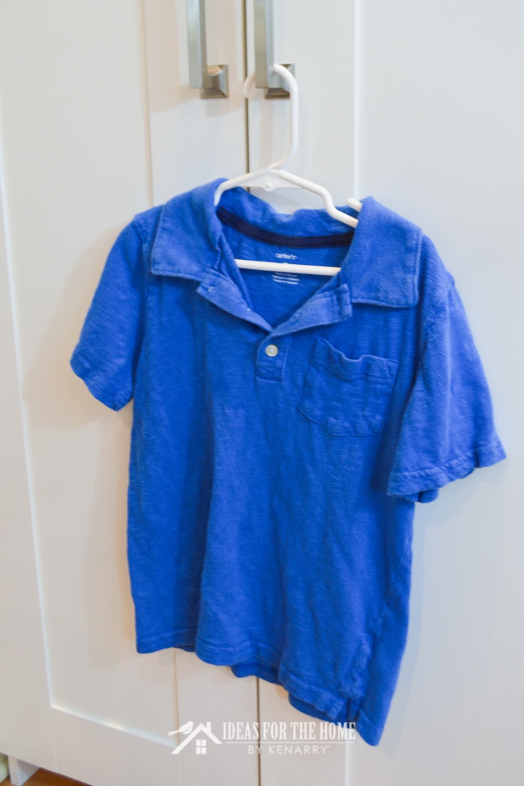 A plain blue short sleeve polo shirt on a hanger