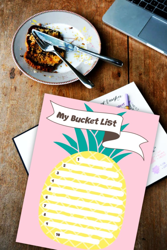 Preview of pink summer bucket list design on wooden counter with view of laptop and plat with breakfast and cutlery. 