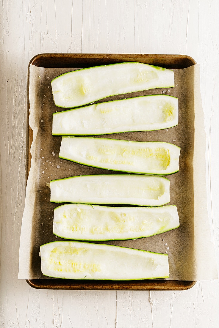 Halved zucchini with seeds removed.