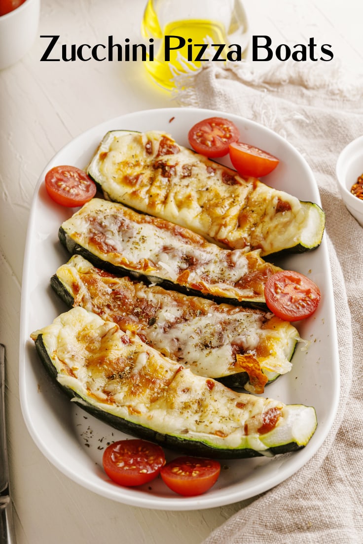 Zucchini pizza boats topped with tomato sauce and cheese.