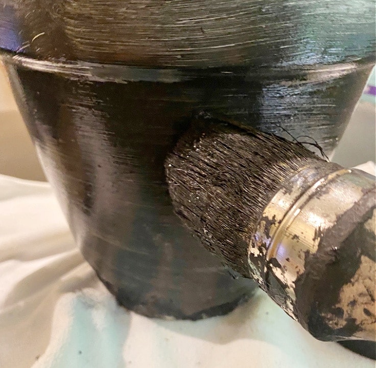 Painting flower pot black.